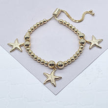 Load image into Gallery viewer, 18k Gold Filled 4mm Beaded Bracelet With Starfish Charms In An Sophisticated Slide Clasp Jewelry
